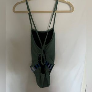 Jolyn Gavin green with colorful cutouts one piece swim suit